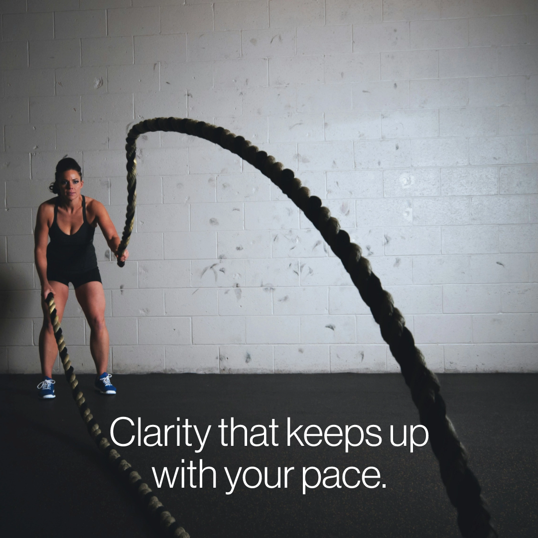 Woman doing battle rope workout in gym symbolizing strength, focus, and performance — caption reads ‘Clarity that keeps up with your pace’ for Elevate 02 campaign.