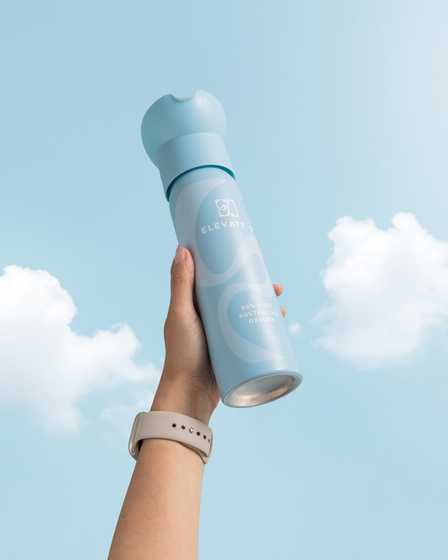 Elevate O₂ portable oxygen can held against blue sky — pure Australian oxygen for energy, focus, and recovery.