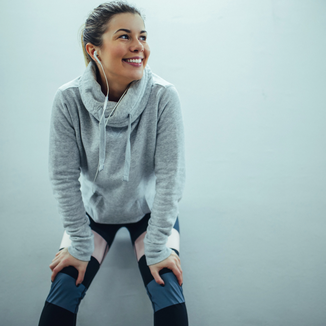 Elevate 02 wellness and recovery — woman in athletic wear smiling post-workout, representing balance, clarity, and renewed energy.